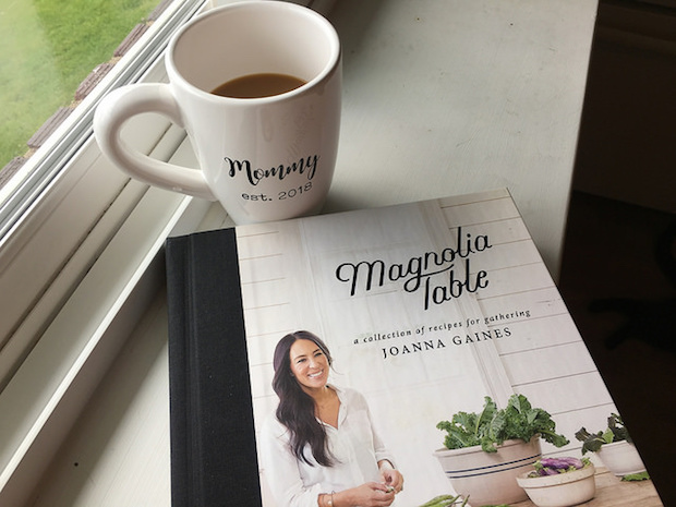 Joanna Gaines Magnolia Table Cookbook and Mom coffee mug with coffee on windowsill