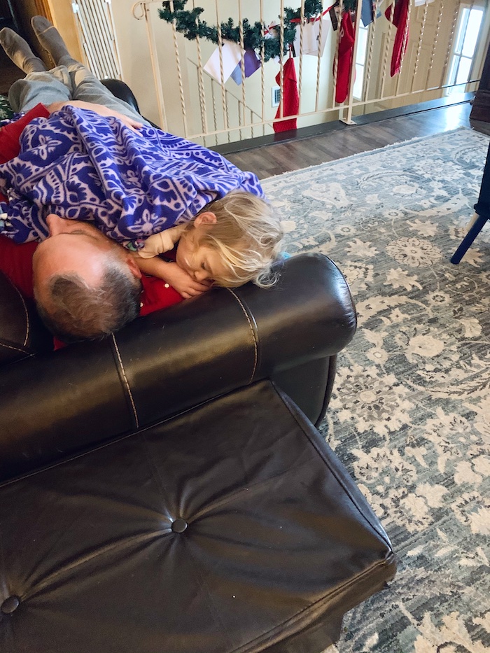 Toddler and grandpa taking a nap together on couch