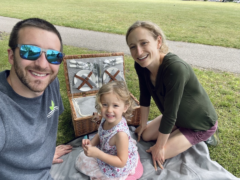 Family with picnic basket in park