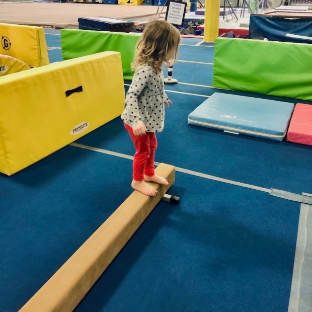 Toddler girl on balance beam
