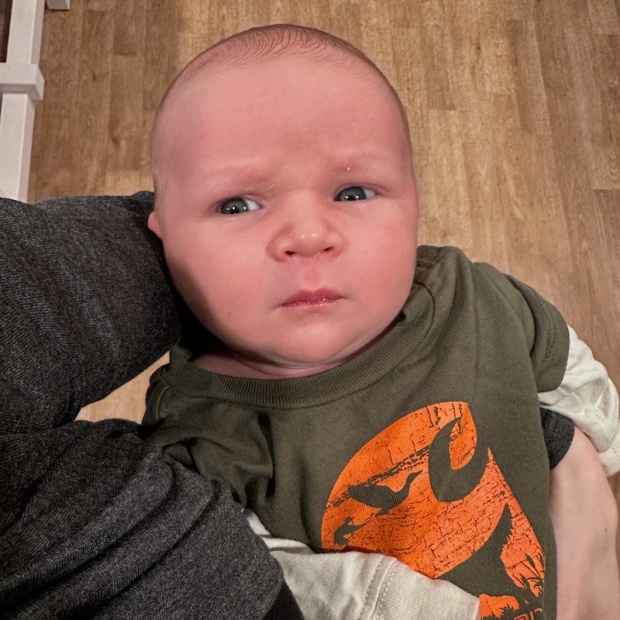 Newborn baby boy in Carhartt onesie