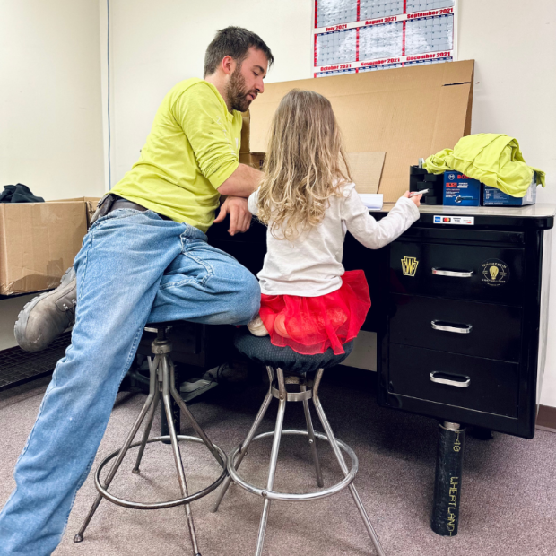 Dad and daughter sitting at desk together